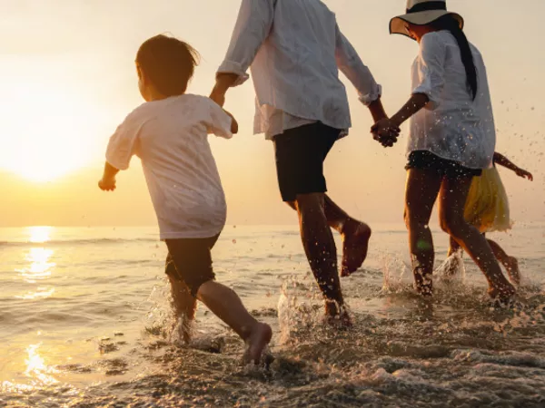 A family enjoys time on the beach after moving to avoid snow.