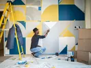 Man painting an accent wall