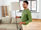 Man prepares to pack a lamp for moving.