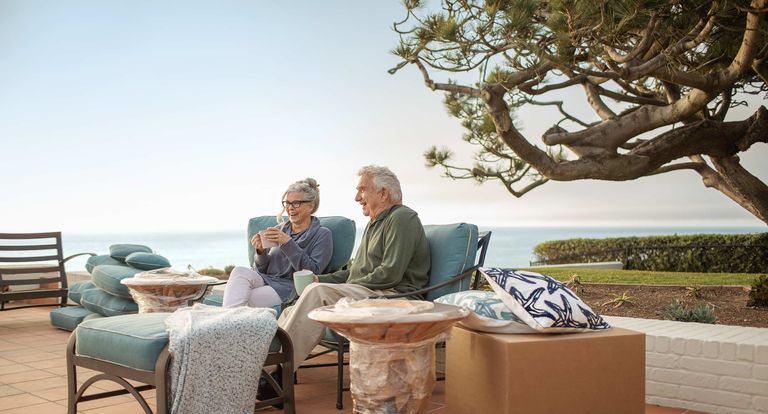 retired couple enjoys a view while taking a break from unpacking