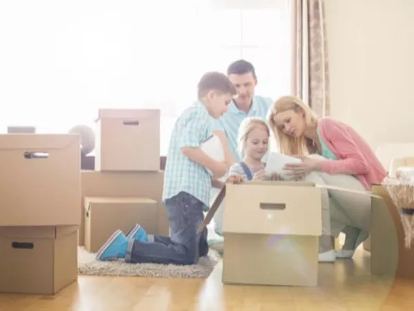 A family unpacking moving boxes in their new home.