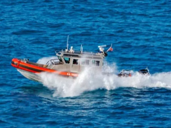 Coast Guard boat on the move through the water.