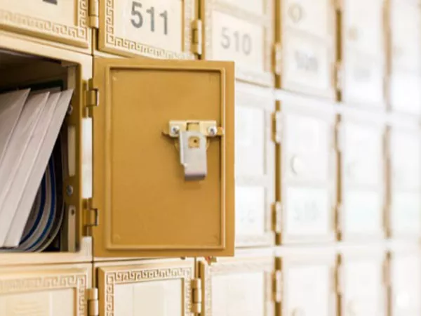 Post Office box full of mail in a new city.