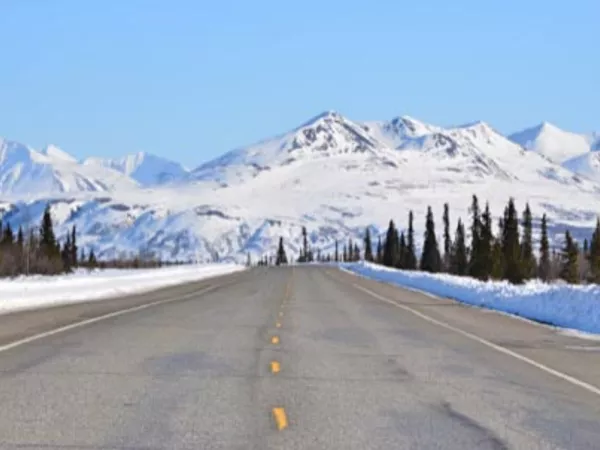 View of open road and Alaskan mountains which you would see when driving to Alaska.