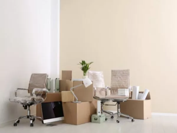 Home office items packed and ready for moving as part of a job relocation.