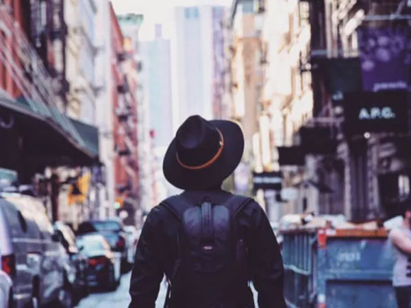 Man walking through the streets of the largest U.S. city by population, New York City.