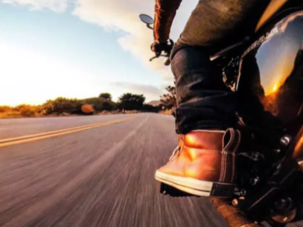 Person driving a motorcycle during a long distance move.