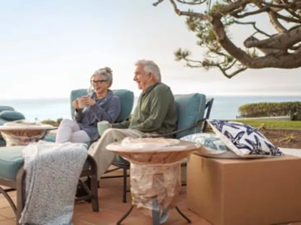 Senior couple relaxing outside after their coast-to-coast move.