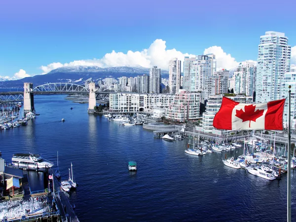 View of a bridge illustrating the move from the U.S. to Canada with a Canadian flag flying in the foreground.