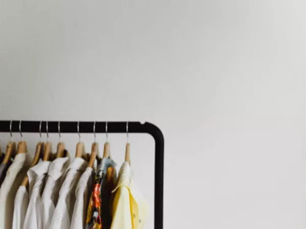 Clothing rack holding hanging clothes before a move.