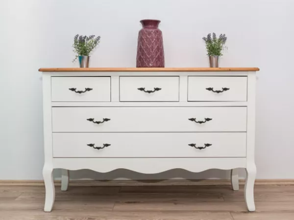 White dresser sitting in a house before a move