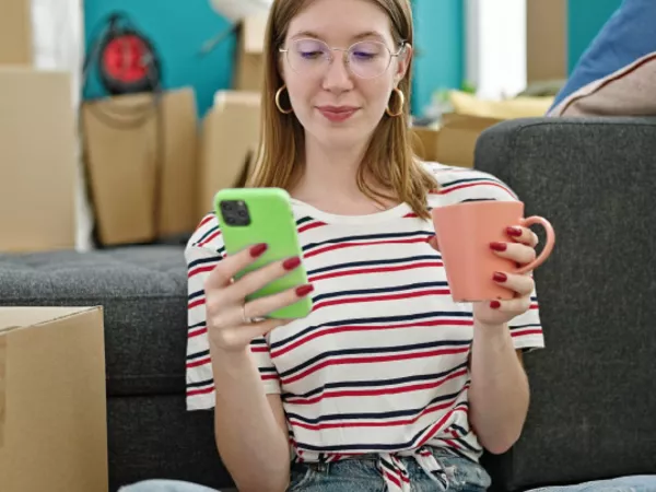 Woman accessing the U-Pack dashboard on her cell phone to manage her move.