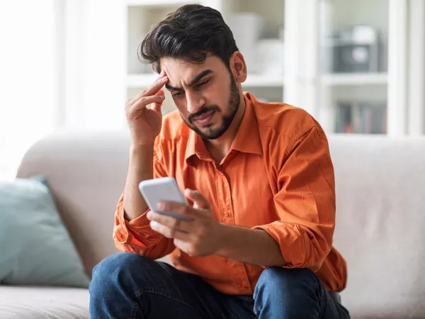 A man reviewing a U-Pack pricing change on his phone.