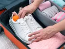 Placing shoes and other clothes in a suitcase