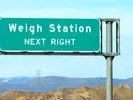 Road sign reading "weigh station next right."