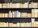 Bookshelf lined with books to be moved.