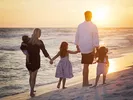 Family arriving on the Florida beach after completing the driving route from New York to Florida.