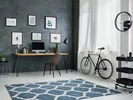 Blue and white patterned area rug in a home office.