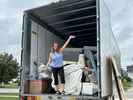 Woman standing in a U-Pack moving trailer with linear footage lines showing clearly on trailer walls.